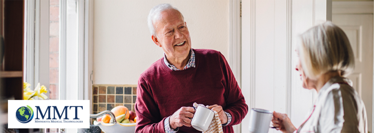 Image of older couple doing dishes together in sunny kitchen setting