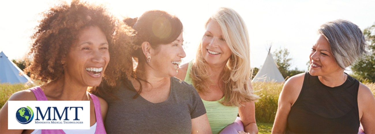 Group of smiling middle aged women outside with yoga mats being active