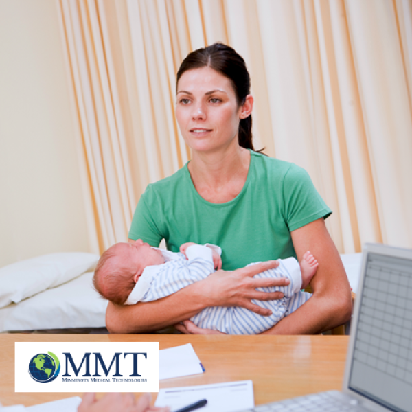 Mom holding baby while speaking to doctor in exam room