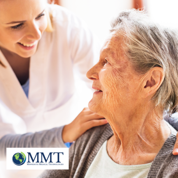 Younger female caregiver smiling with her arms around the shoulders of a senior woman who is also smiling
