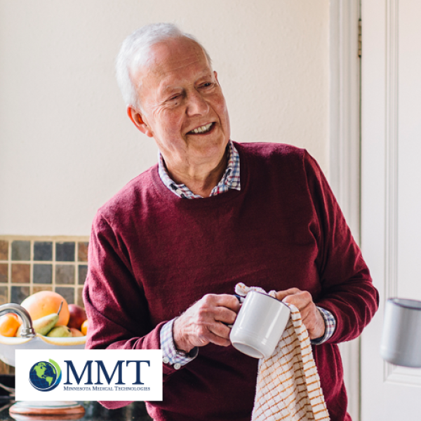 Image of older man drying dishes in sunny kitchen setting