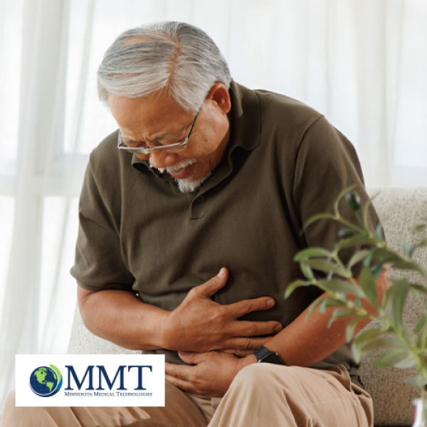 Man sitting down and holding hands around stomach to indicate stomach cramps from constipation